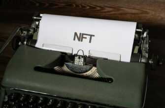 Close-up of a vintage typewriter with the word 'NFT' typed on paper, symbolizing digital innovation.